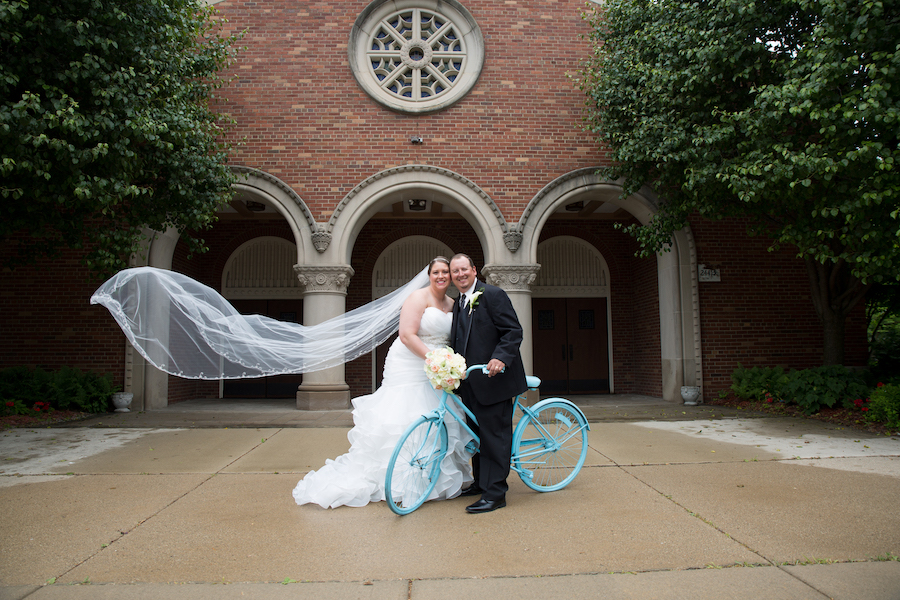 bride and groom with a bicycle wedding transportation