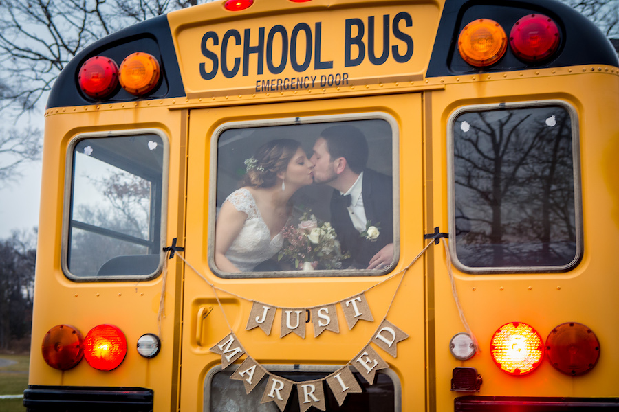 bride and groom riding on school bus