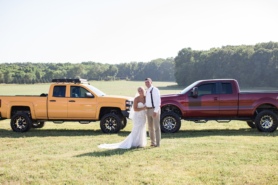 bride and groom with matching trucks