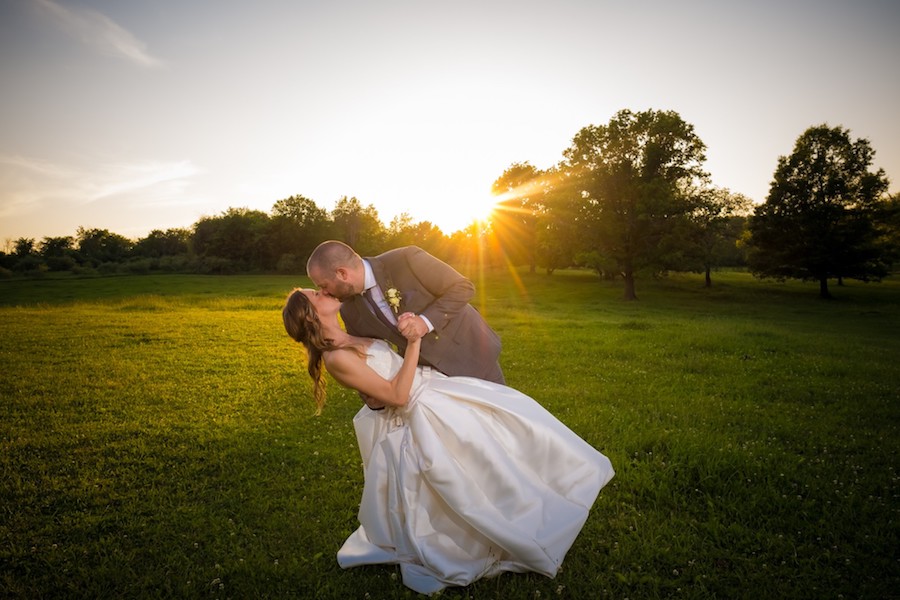 The Oakley Wedding Venue bride and groom kissing sunset