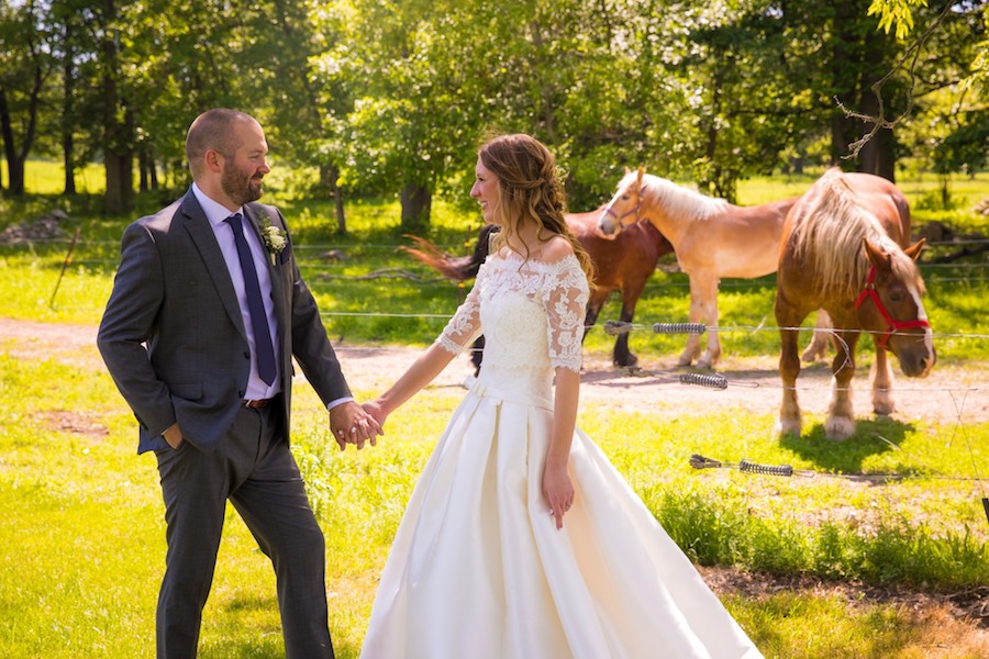 The Oakley Wedding Venue bride and groom with horses holding hands