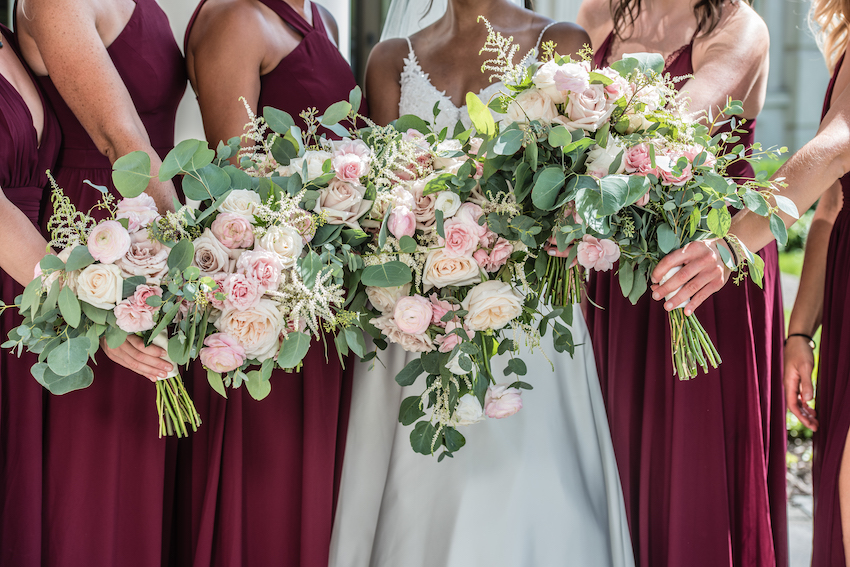 bride and bridesmaids holding fall florals