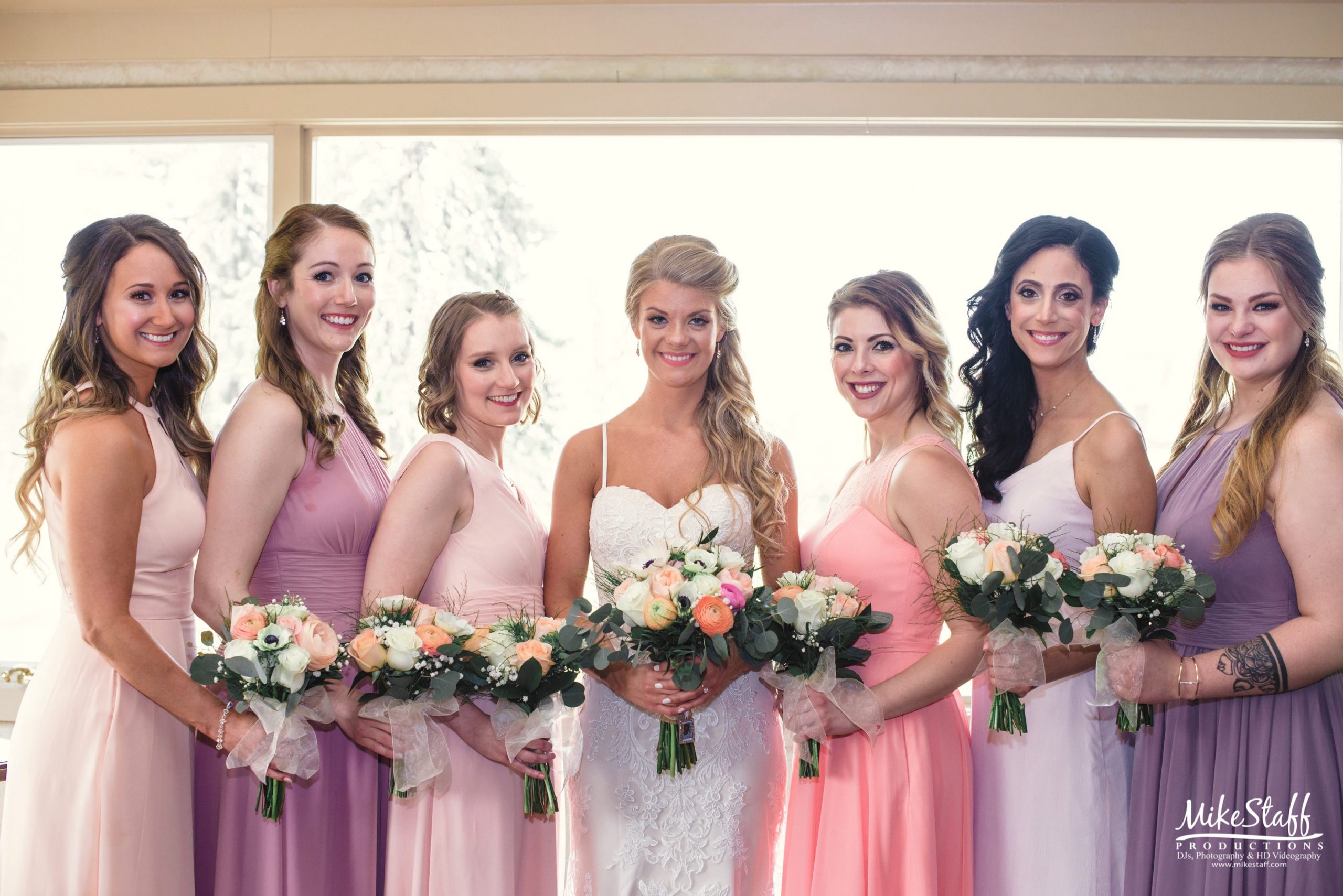 bride with bridesmaids in pastels