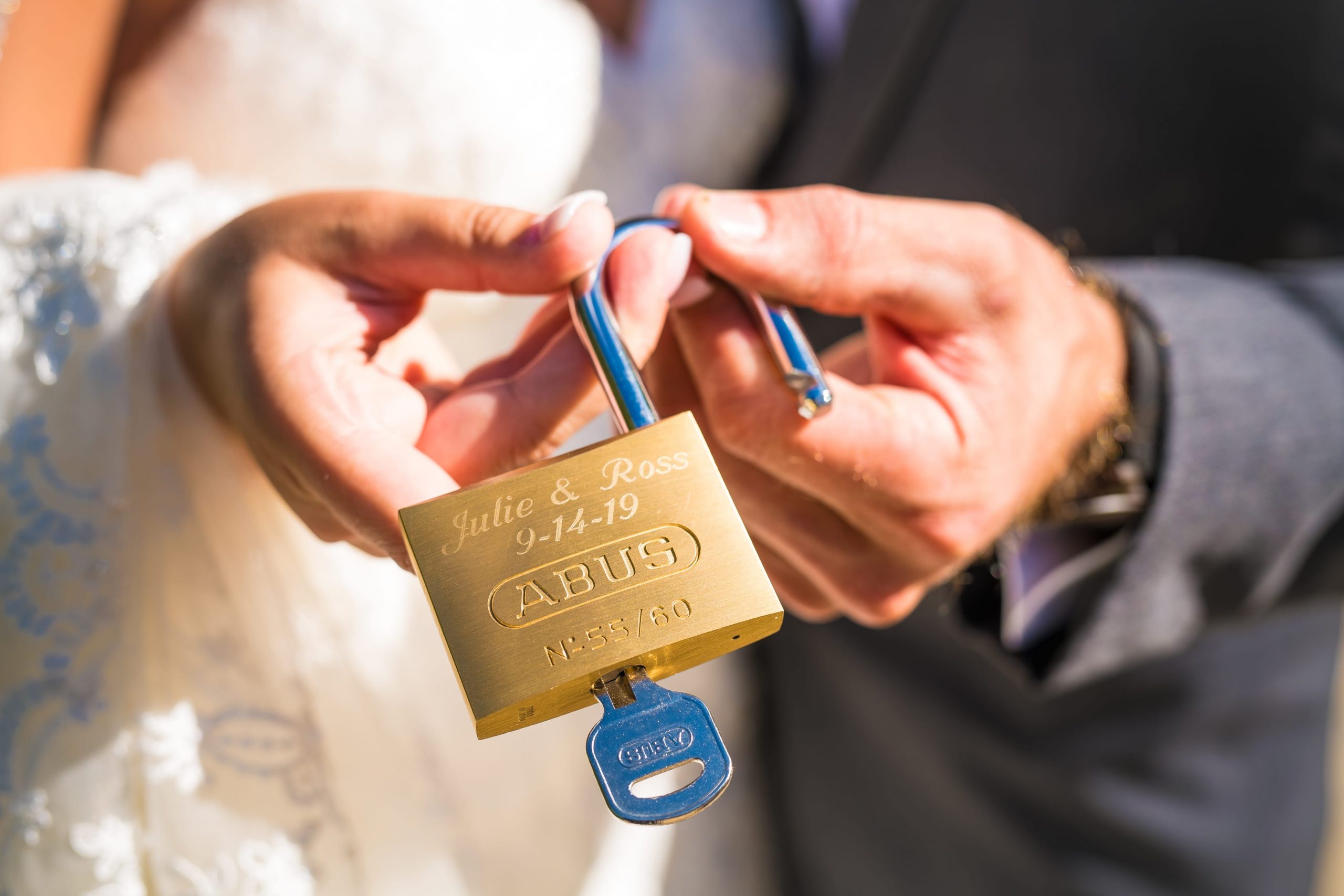 bride and groom holding a lock and key