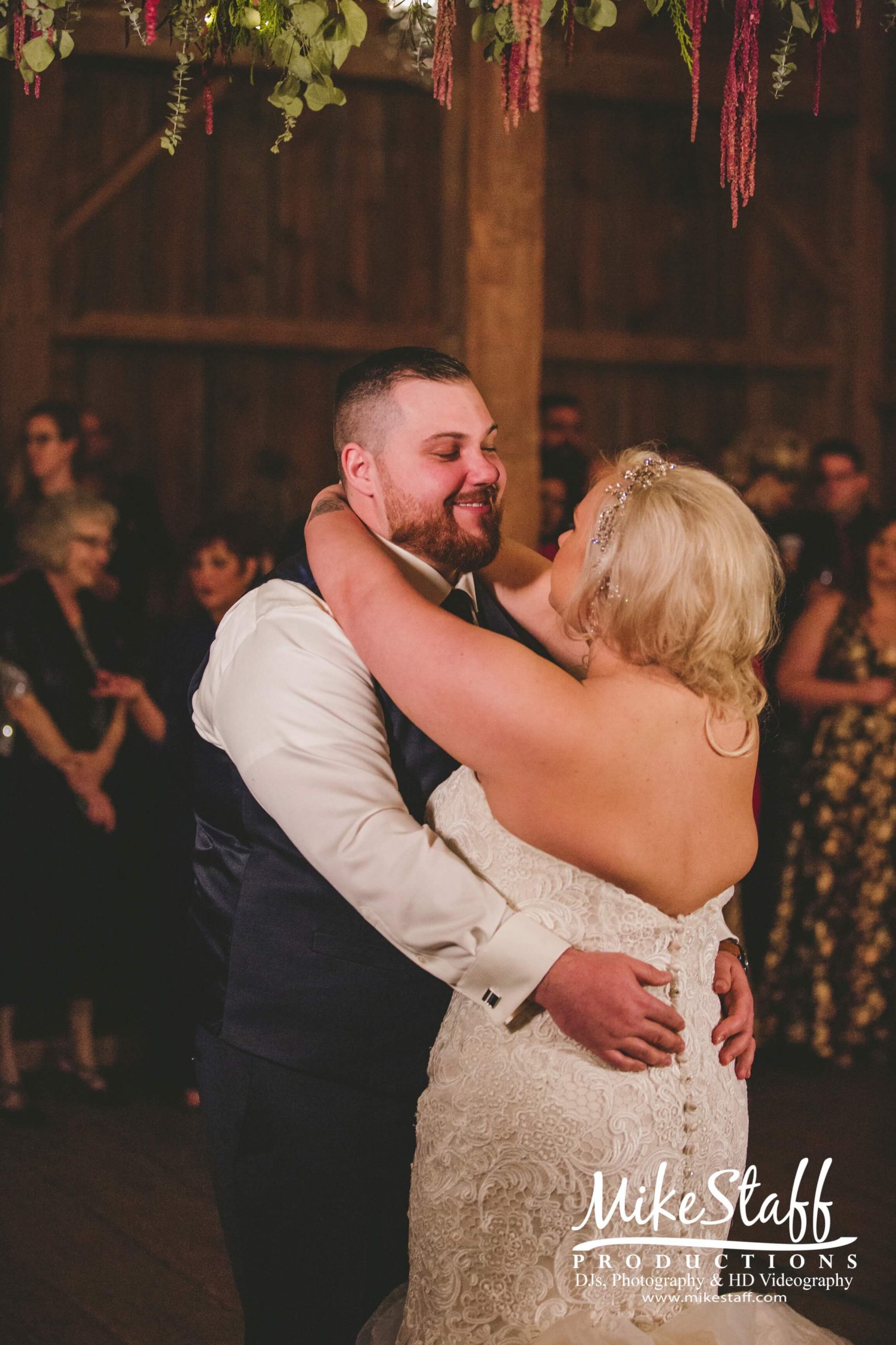 bride and groom's first dance at barn wedding reception