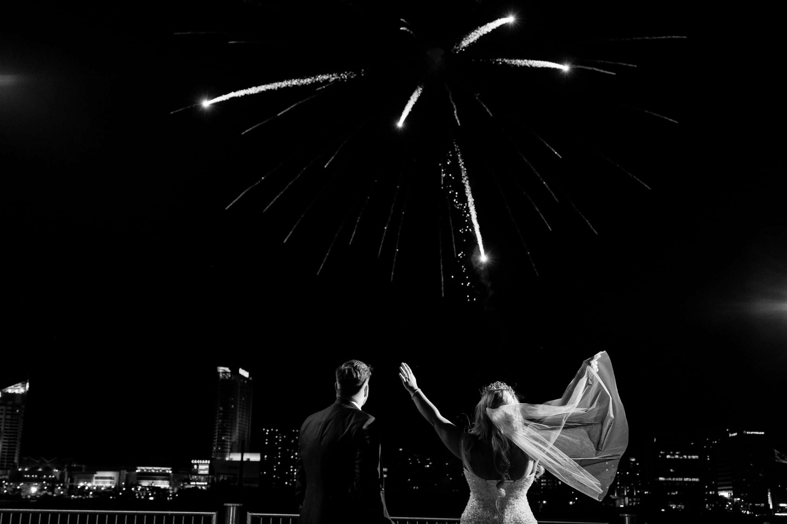 black and white photo of bride and groom watching fireworks