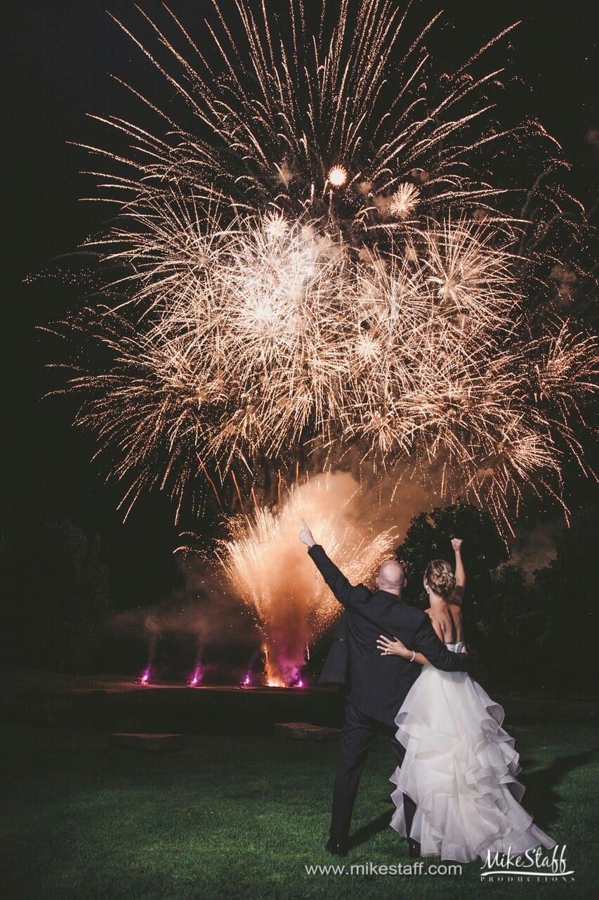 bride and groom watching fireworks display