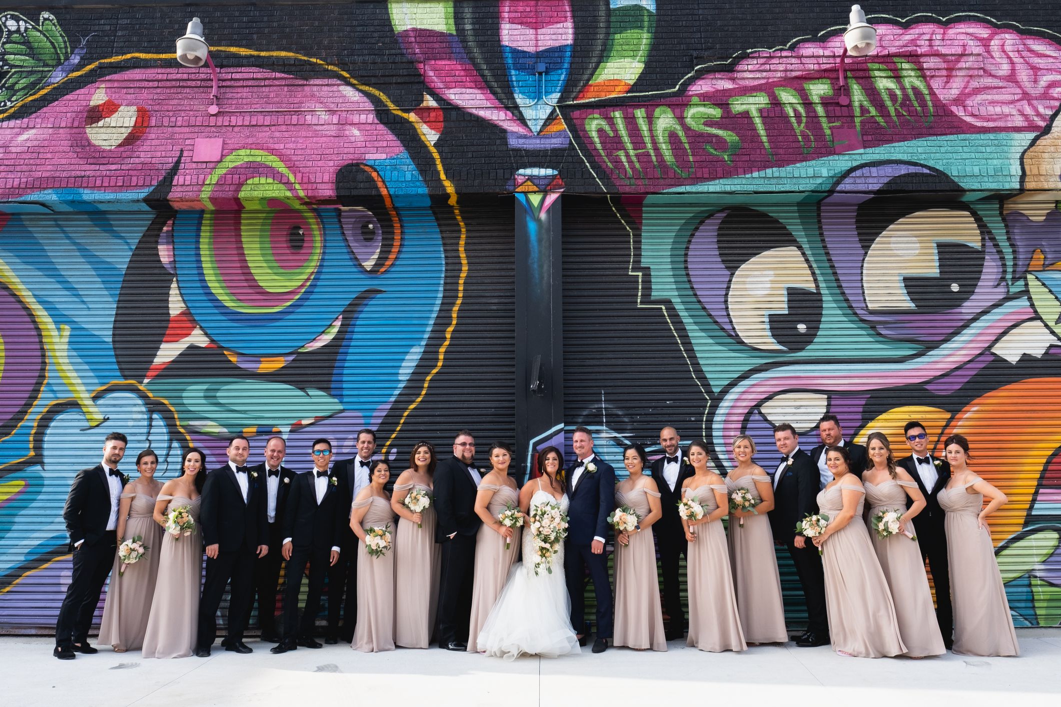 bridal party in front of detroit mural