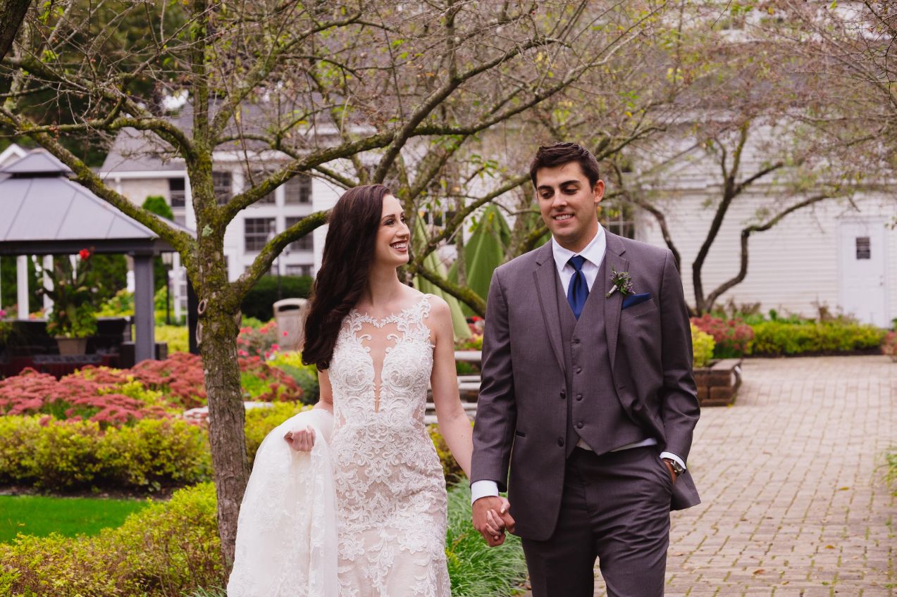 bride and groom walking through wellers