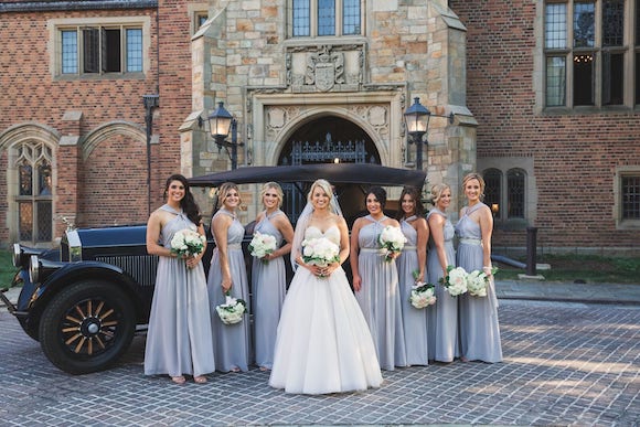 bride and bridesmaids in front of Meadow Brook Hall