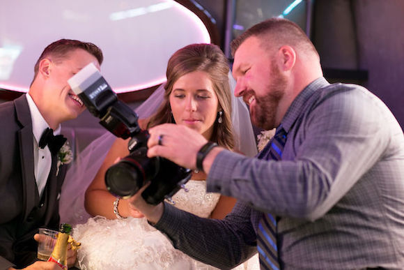 photographer showing bride the photo