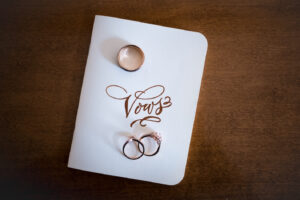 wedding rings on vows booklet - featured weddings