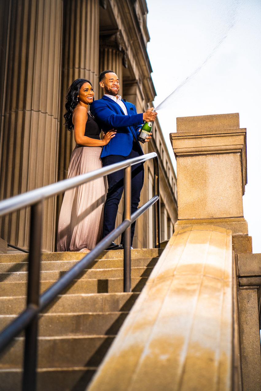 popping champagne at detroit engagement session