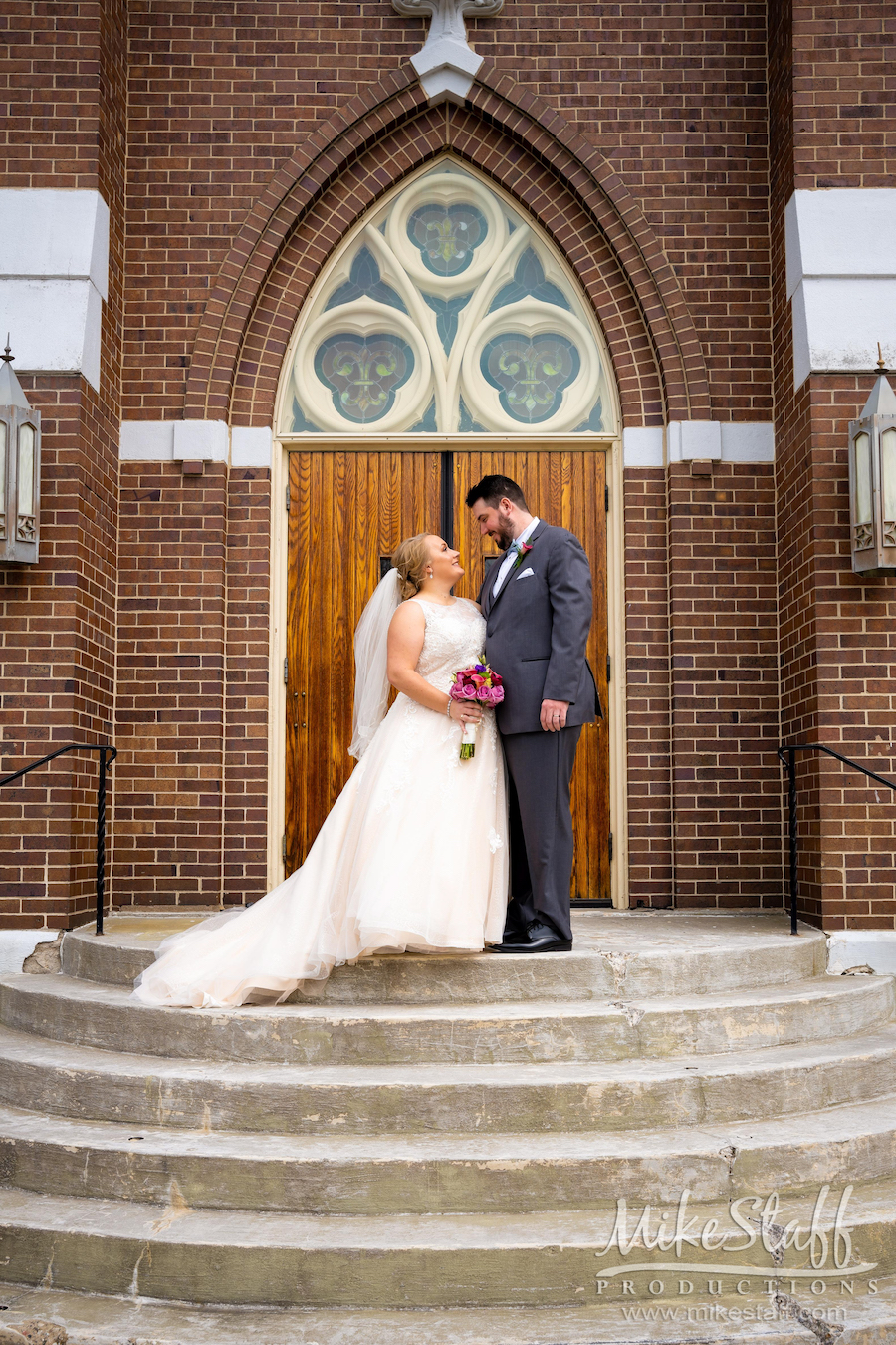 bride and groom outside church doors
