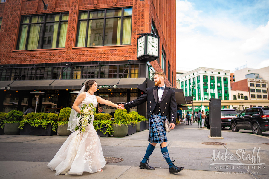 groom in kilt walking with bride downtown detroit