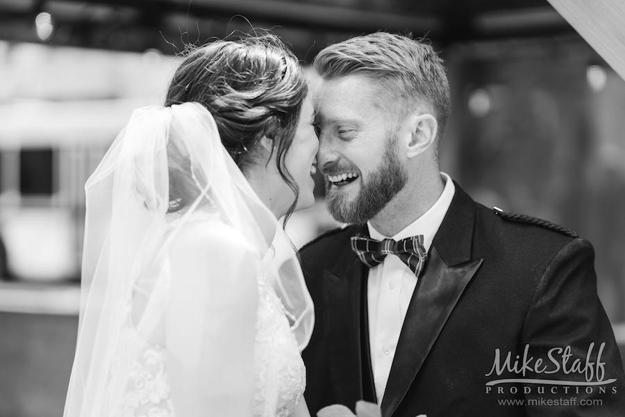 bride and groom up close laughing black and white