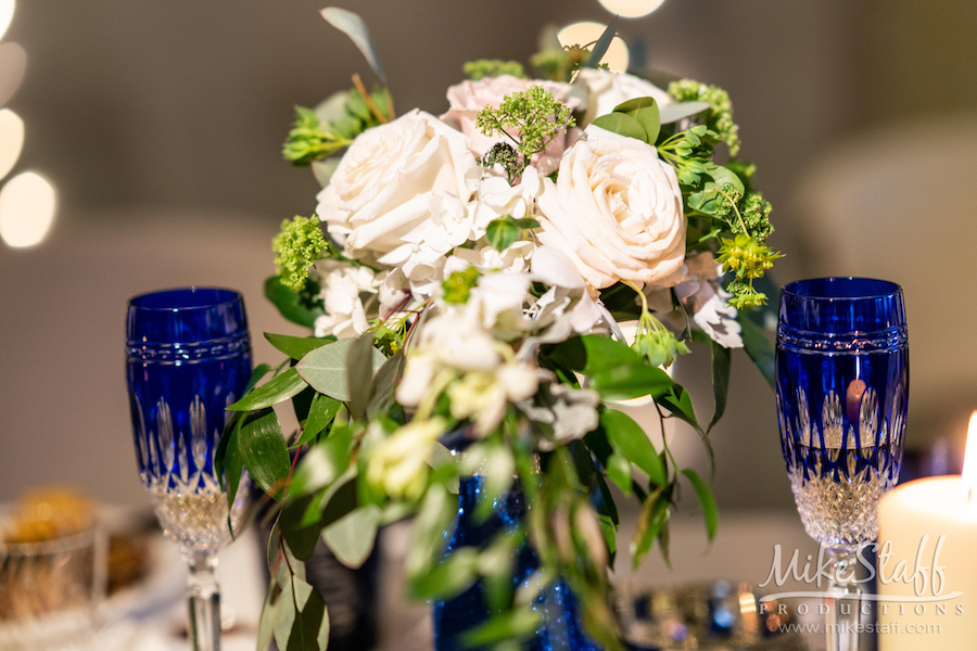 white rose reception centerpiece with blue flutes