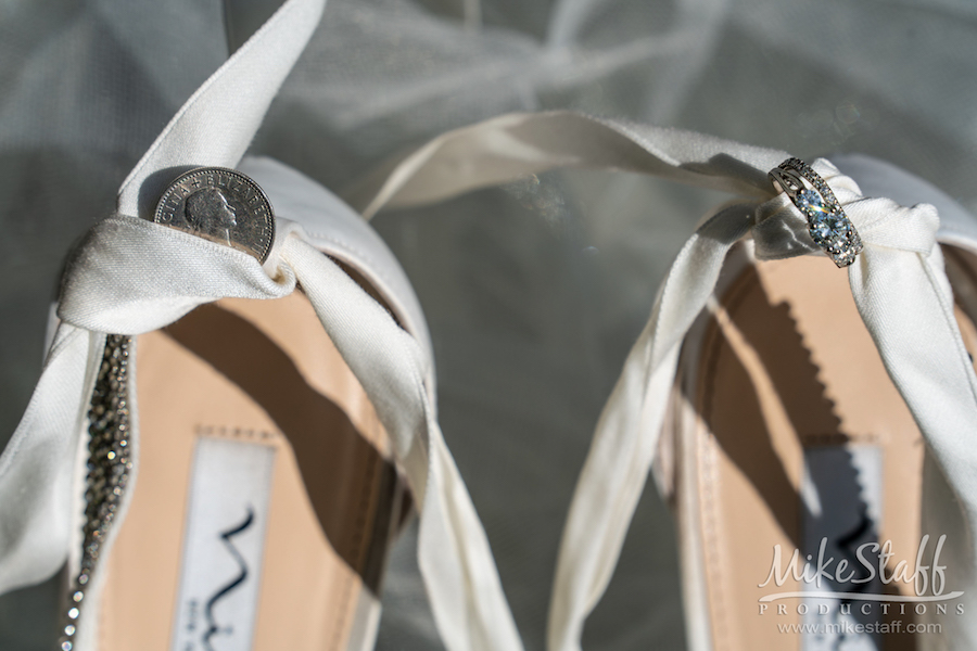 white wedding shoes with ring and lucky coin