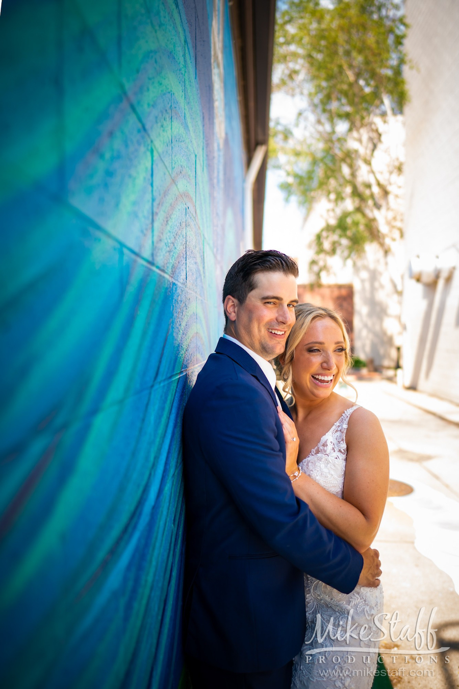 bride and groom by wall mural