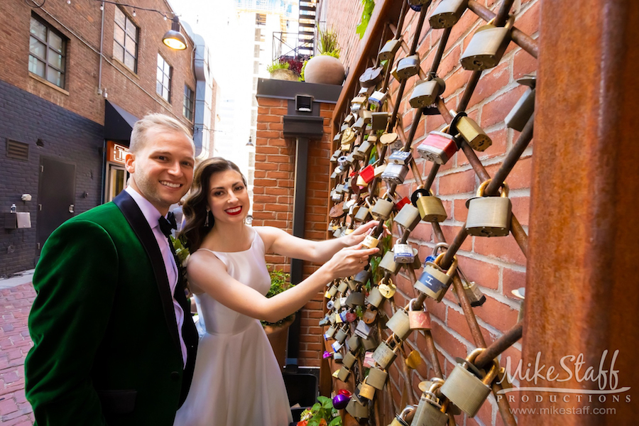 bride and groom placing lock in belt detroit