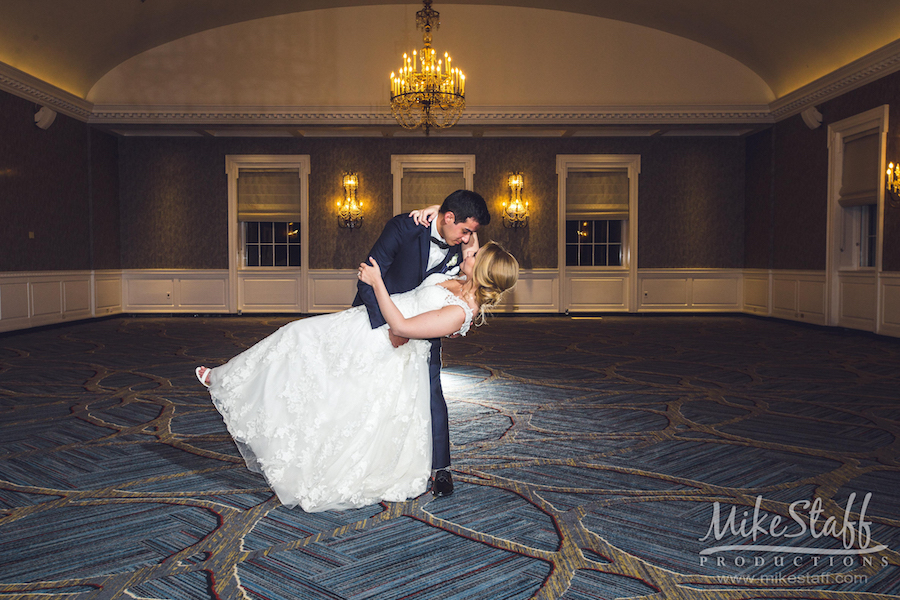 groom dipping bride in ballroom at The Dearborn Marriott