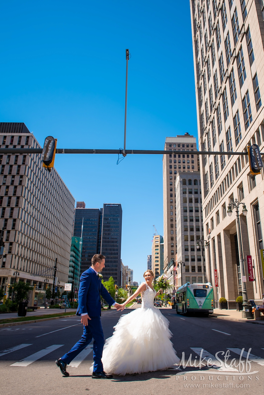 bride and groom crossing street in detroit