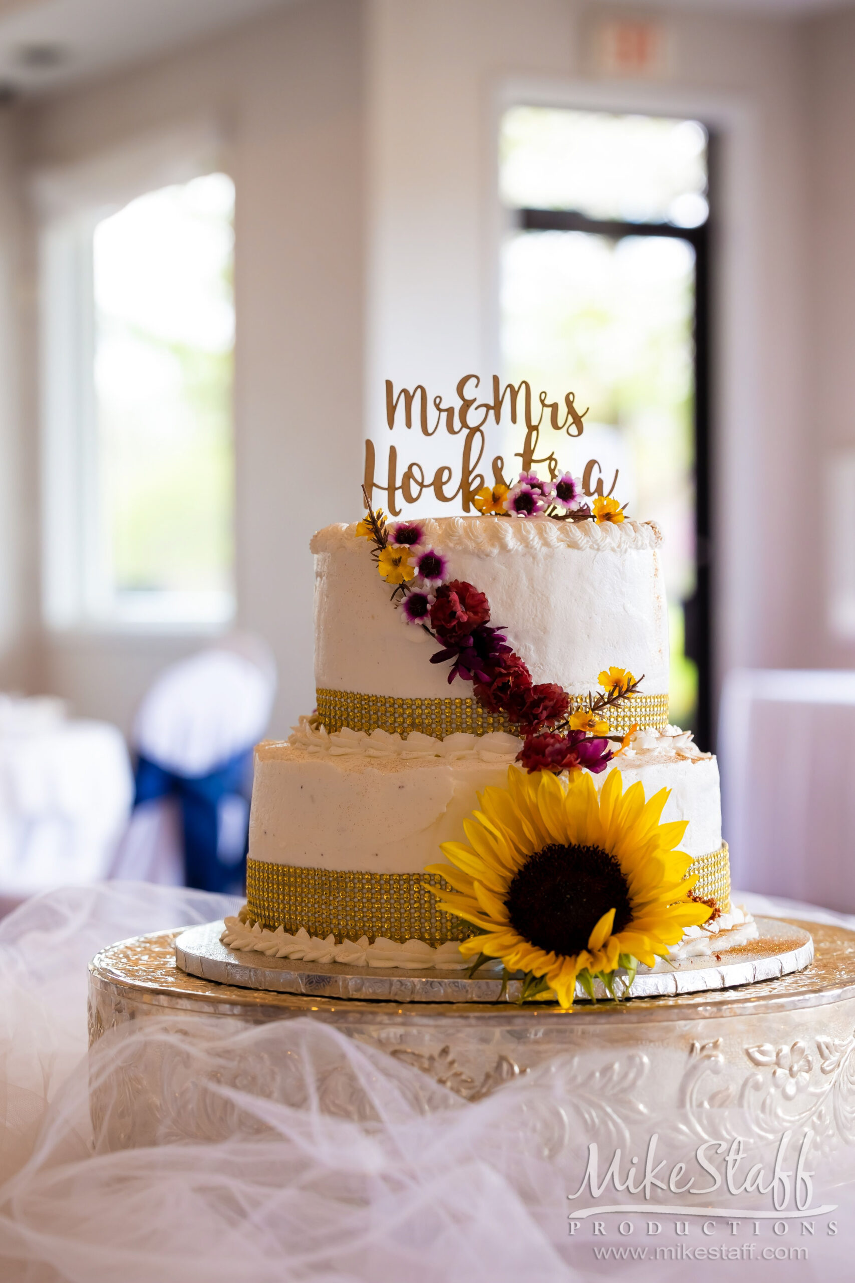 two tiered wedding cake with sunflower