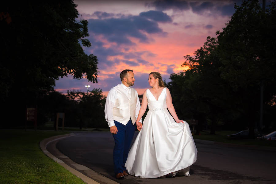 bride and groom walking sunset