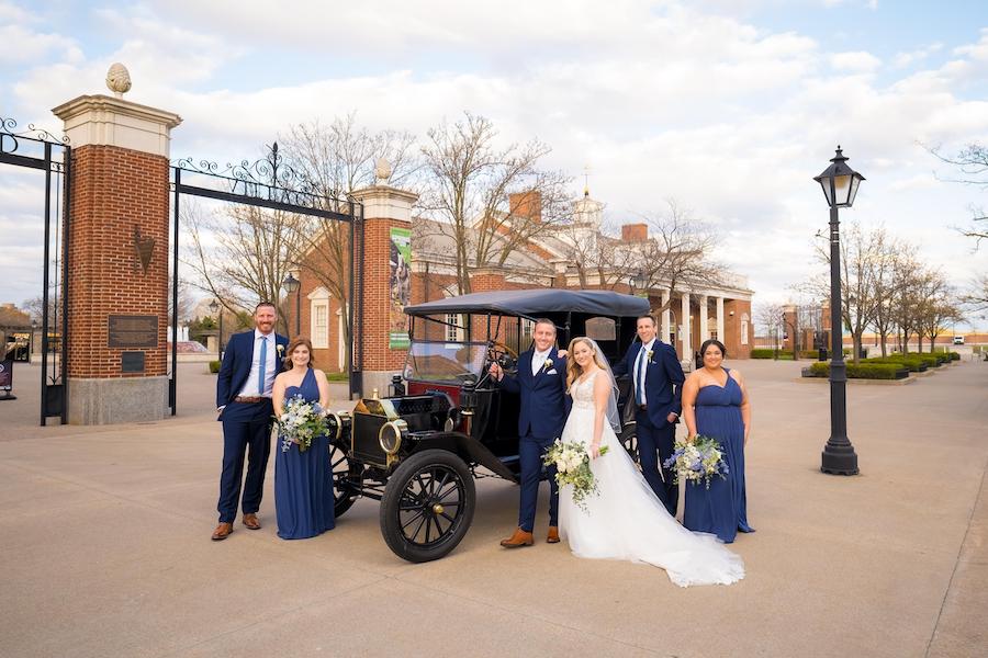 small wedding party by classic car
