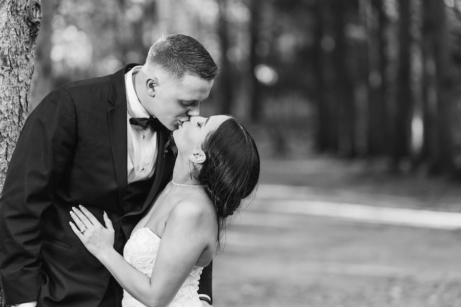 bride and groom kissing outside