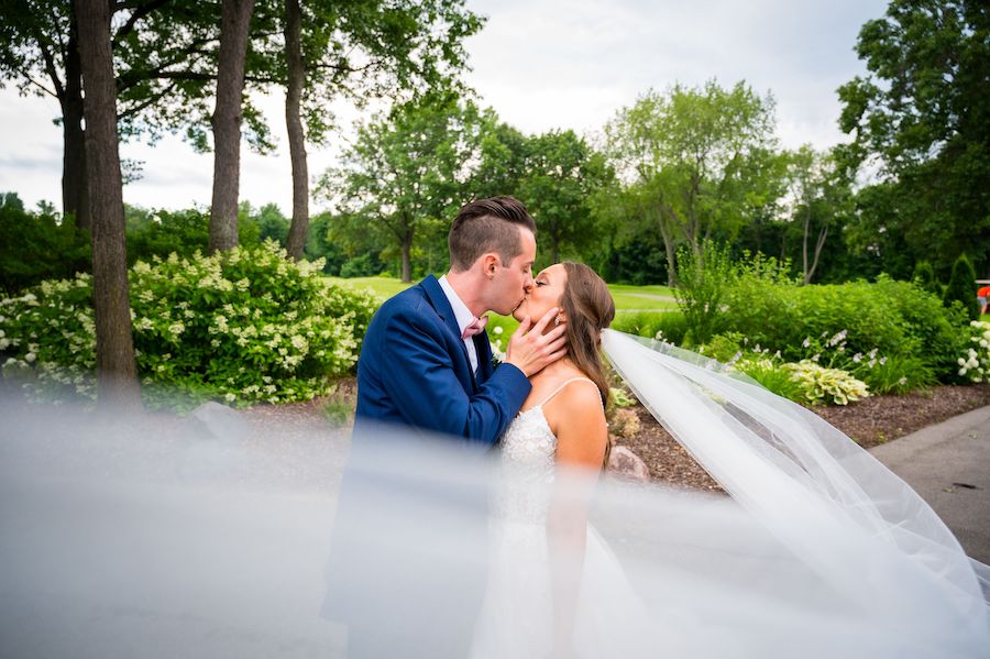 Mike Staff Productions Detroit Wedding Photographer_bride and groom kissing outside with veil flowing