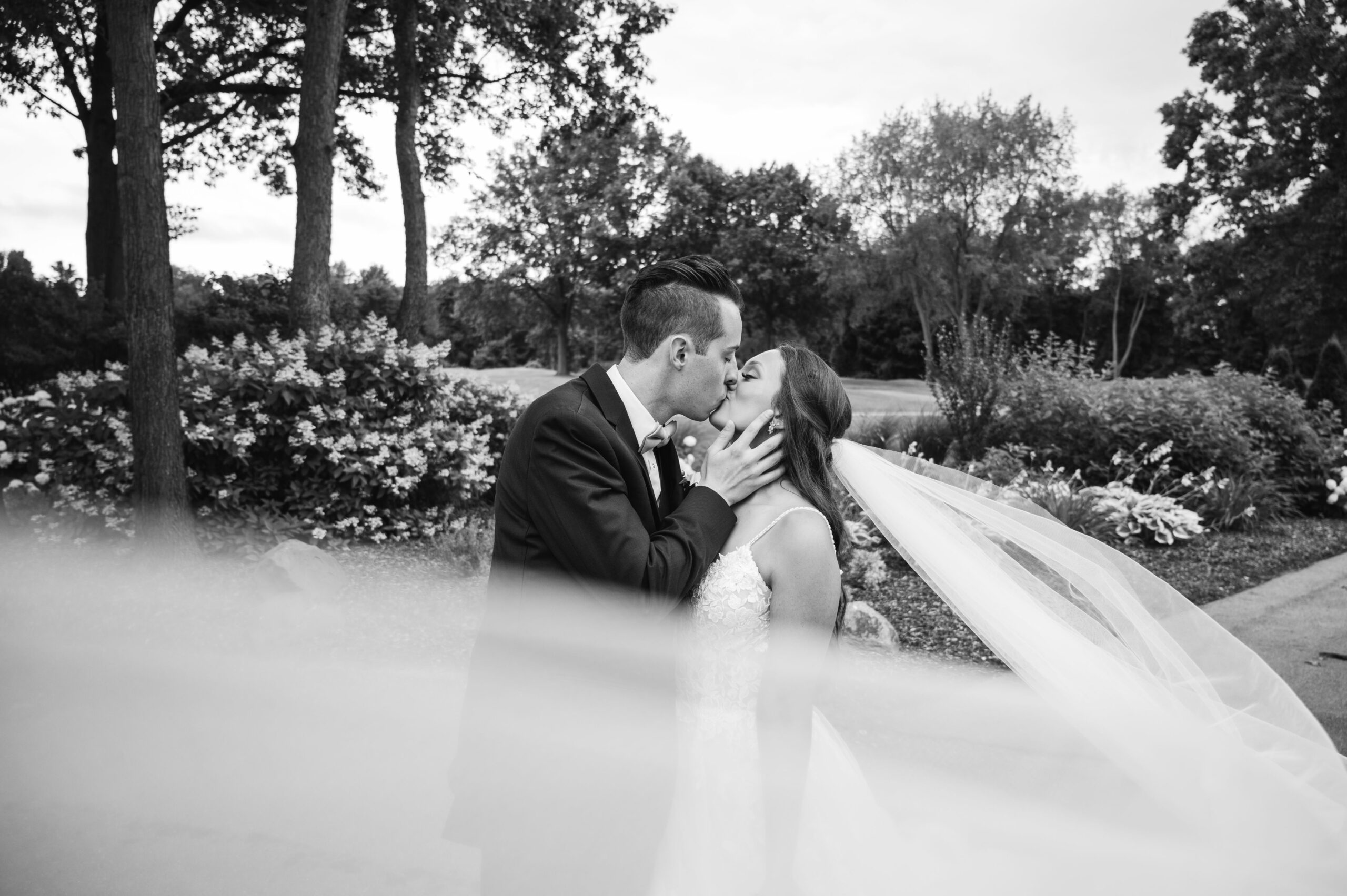 Mike Staff Productions Detroit Wedding Photographer_bride and groom kissing veil flowing black and white