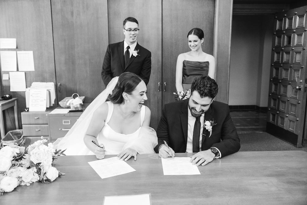 Detroit Wedding Photography at Saint Johns Resort_bride and groom signing marriage license