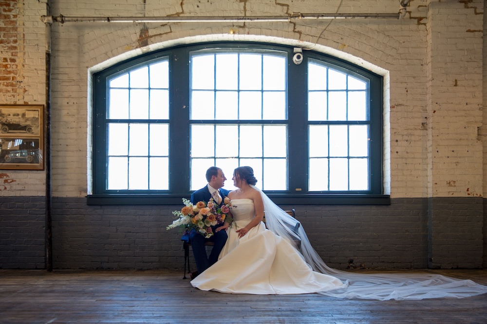 Wedding Photography at Ford Piquette Plant_bride and groom sitting under window